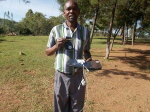 The head teacher with all the pieces to power and use the kindle at their rural school 